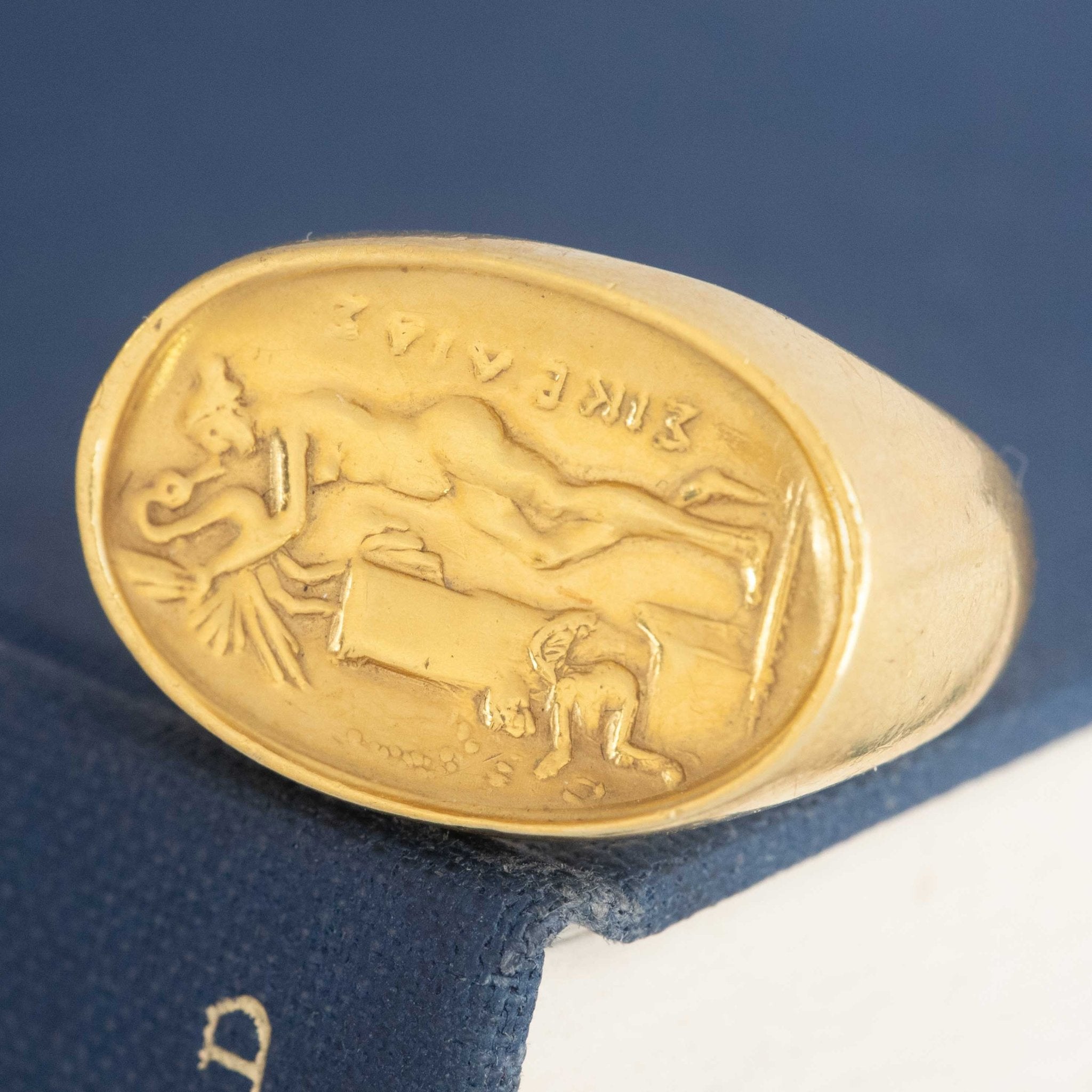 A vintage high karat signet ring  by designer Zolotas depicting "Leda and the swan."  One of a kind and a rare jewel.