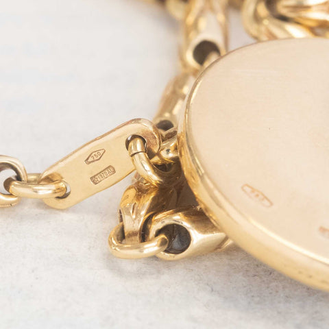 Vintage Bvlgari Leo zodiac pendant crafted in Italy from 18‑karat yellow gold with a contrasting stainless‑steel or white‑gold outer ring. The circular disc is engraved with the BVLGARI logo and features the Libra scales motif at the centre, and it bears hallmarks such as ‘Made in Italy’ and ‘750’.  Measuring roughly 1.23 inches in diameter and weighing about 13 grams, the pendant is numbered on the reverse and hangs from a substantial bail for easy wear as a charm or necklace.  
