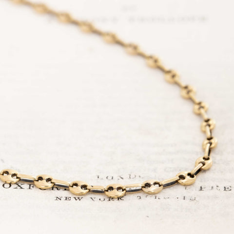 Vintage Italian 14k yellow gold mariner link chain necklace on white background

Close-up of Italian-made 14kt yellow gold mariner links, 3.95mm wide