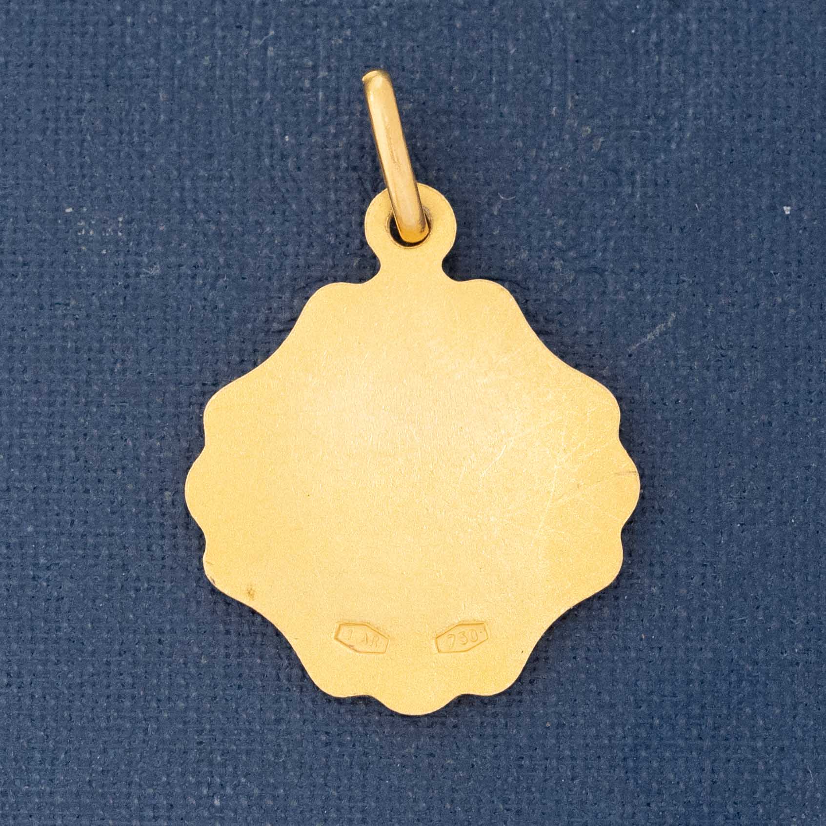 Gold pendant on a blue background