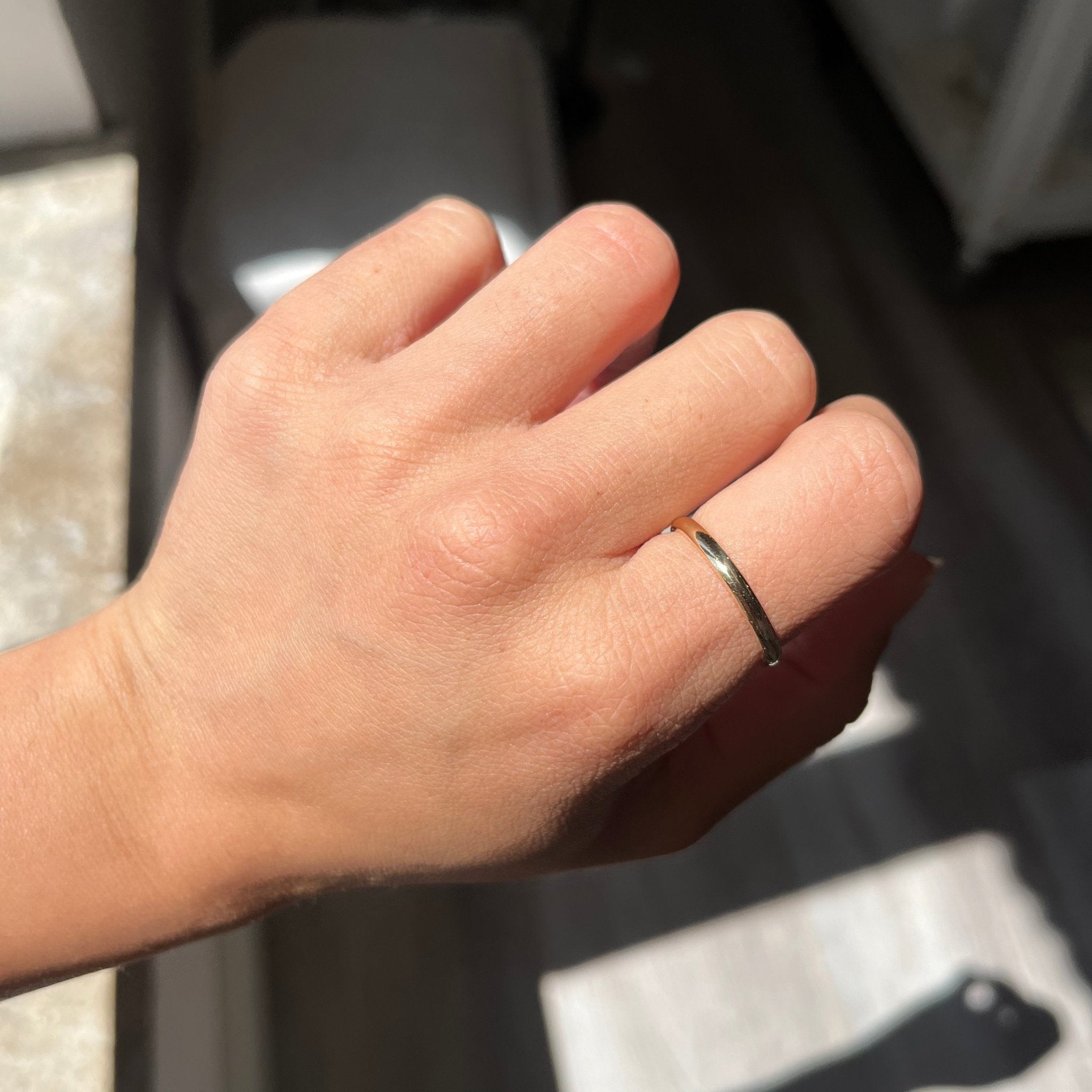 vintage slim 18kt yellow gold wedding band sitting on finger