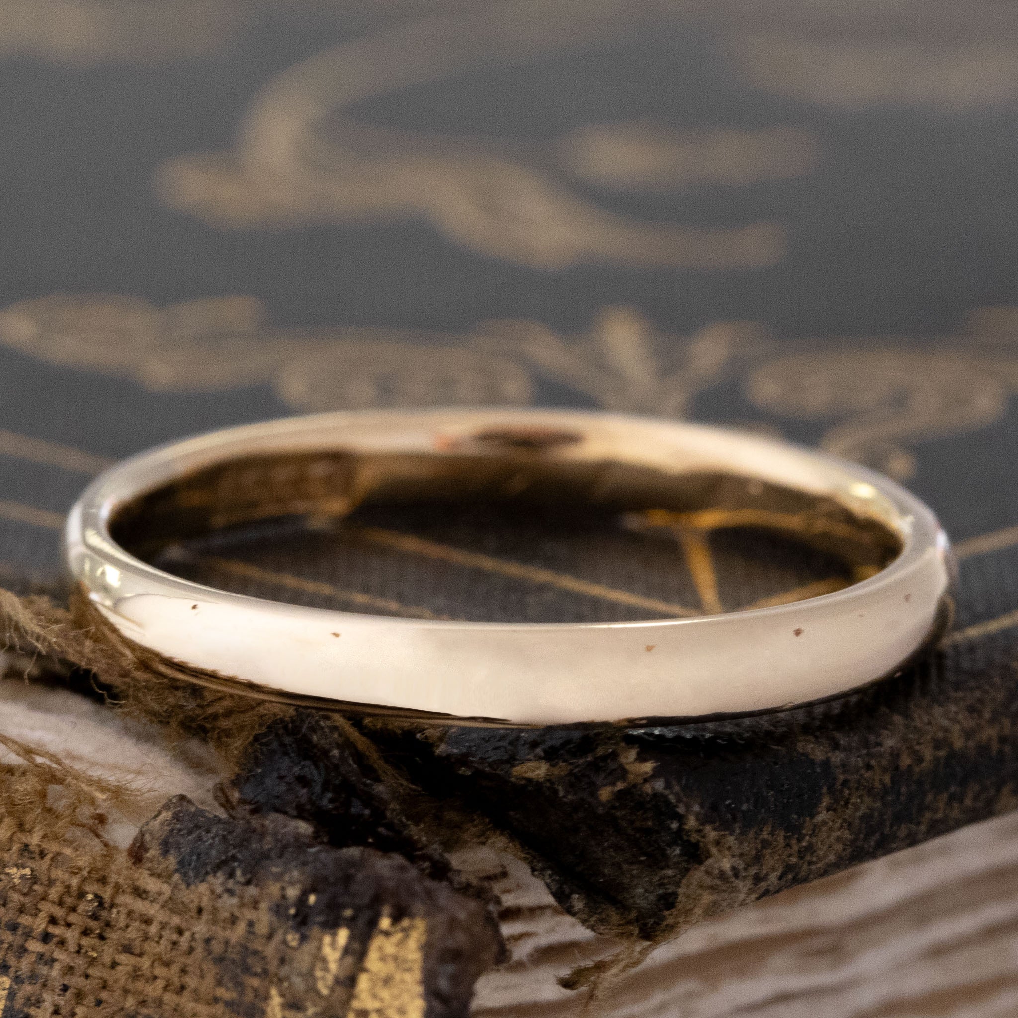 vintage slim wedding band 18kt yellow gold sitting atop a brown antique book corner