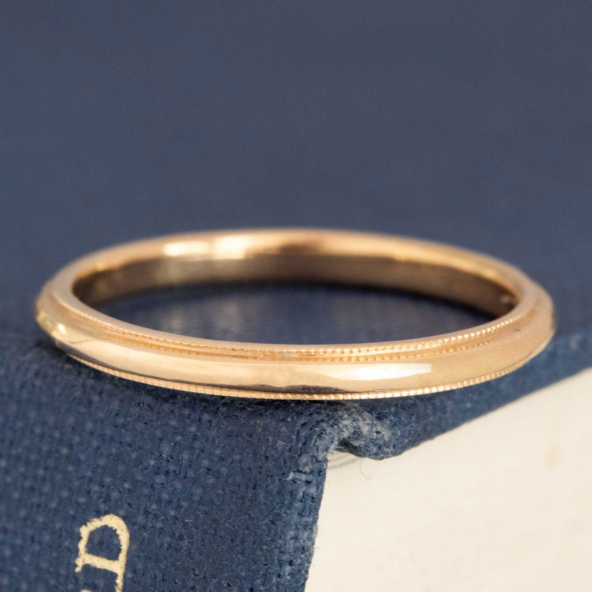 Slim 14kt yellow gold wedding band with milgrain on edges.