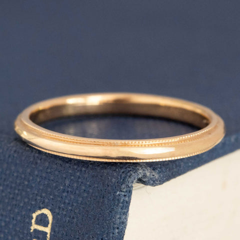 Slim 14kt yellow gold wedding band with milgrain on edges.