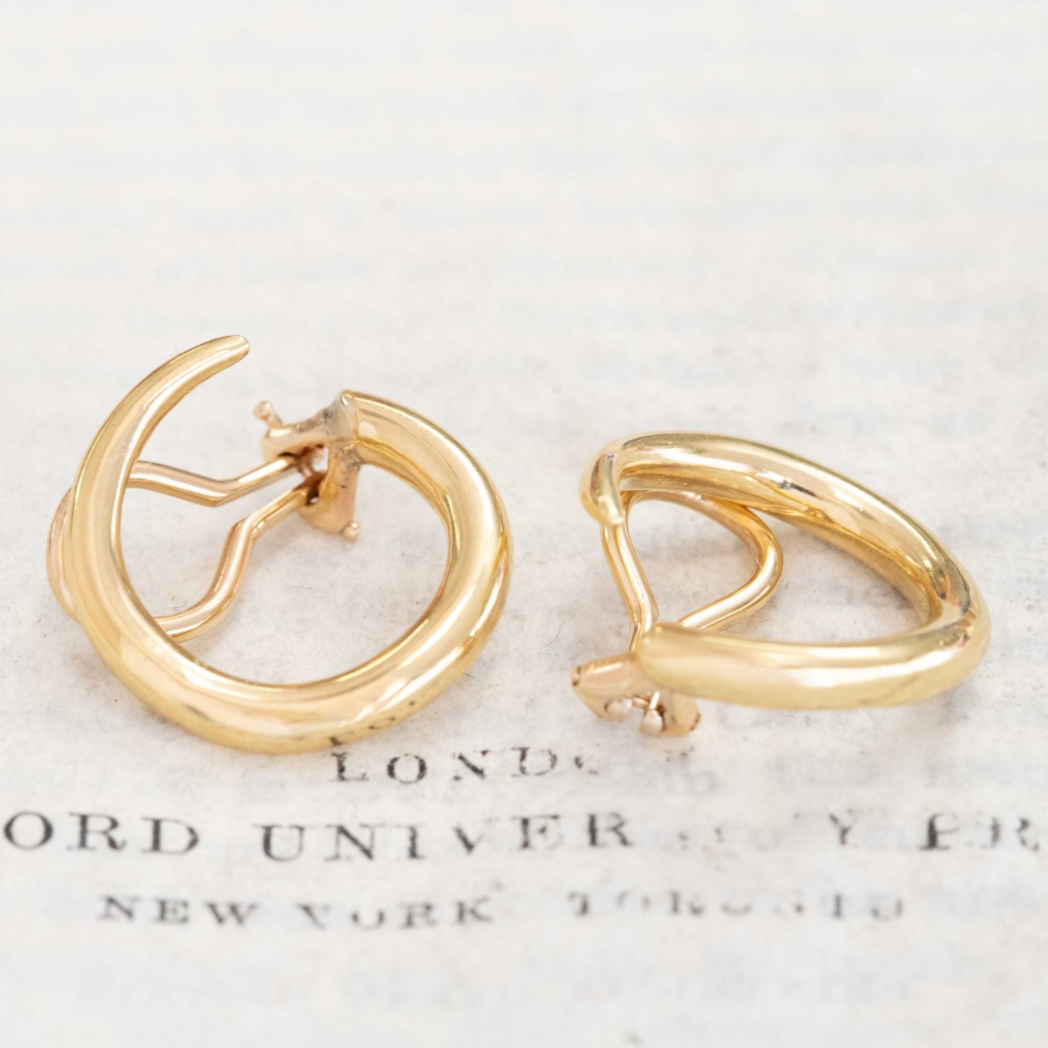 Close-up of vintage Aldo Cipullo gold earrings, chic clip-on design