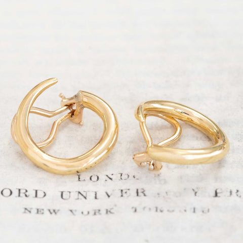 Close-up of vintage Aldo Cipullo gold earrings, chic clip-on design
