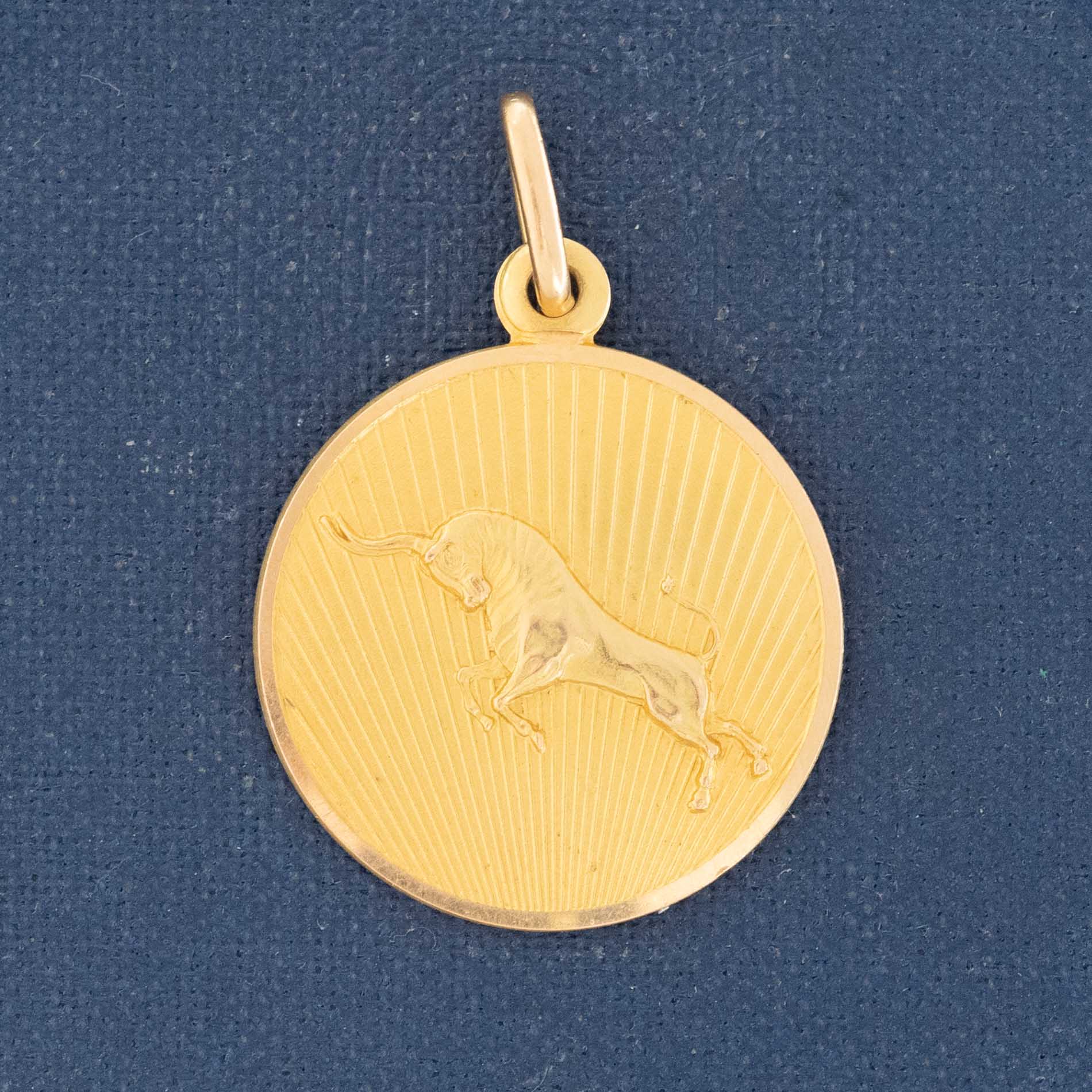 Vintage 18K gold Taurus pendant with sunburst design