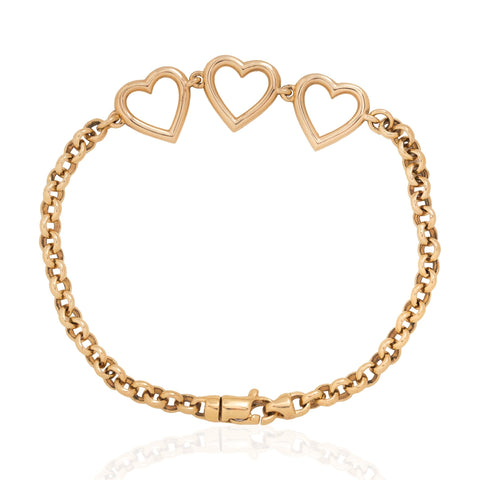 A vintage gold chain bracelet featuring three interlocking open heart charms at the top, displayed on a clean white background with a subtle reflection below.