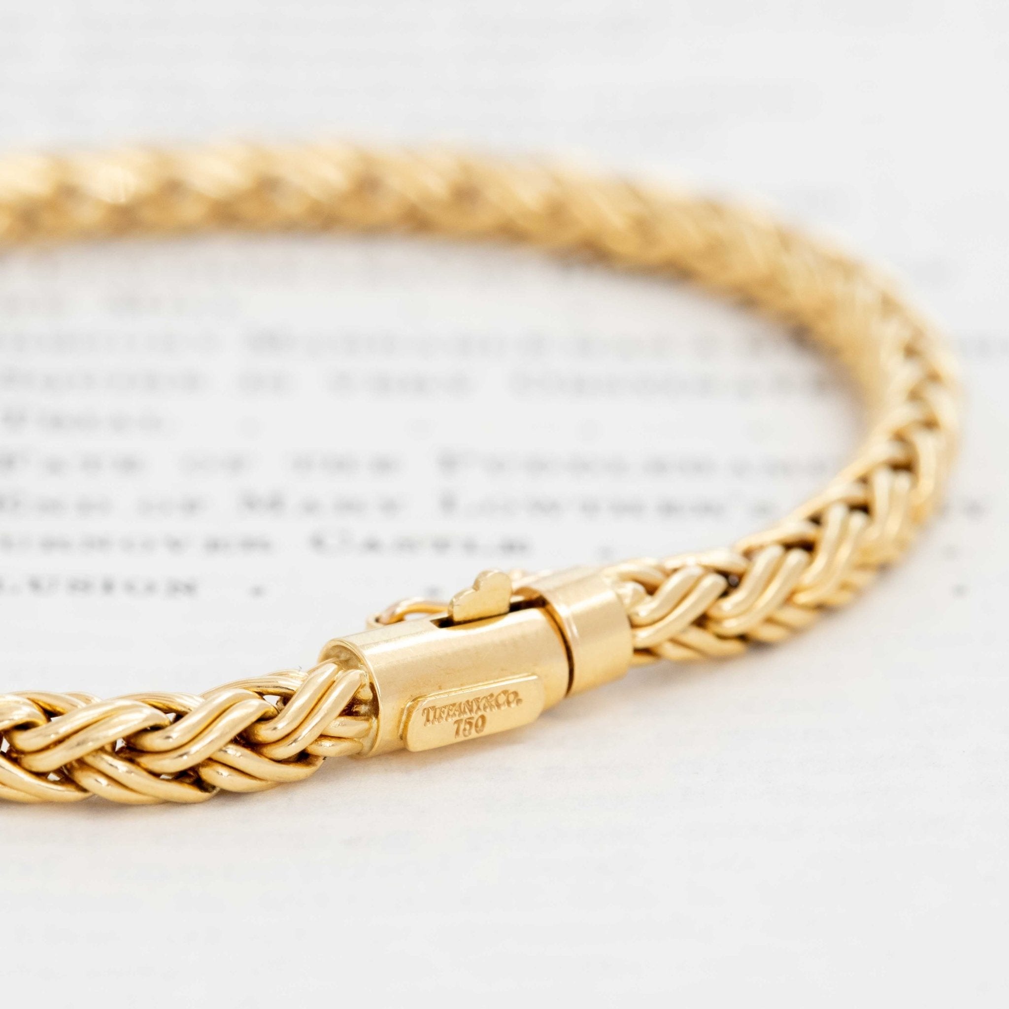 Close-up of braided gold Tiffany bracelet. Classic Tiffany braided gold bracelet, vintage era