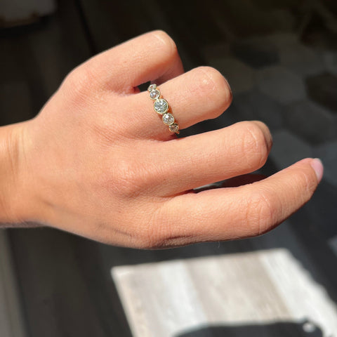 Elegant .93ctw Old European Cut Diamond Graduated 5-Stone Band, romantic design with Old Mine Cut Diamonds, Earth-mined diamonds in yellow gold shown on ring finger